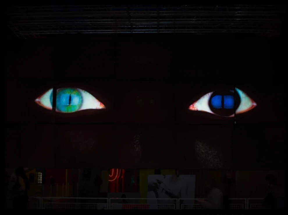 Two projected eyes on a dark wall