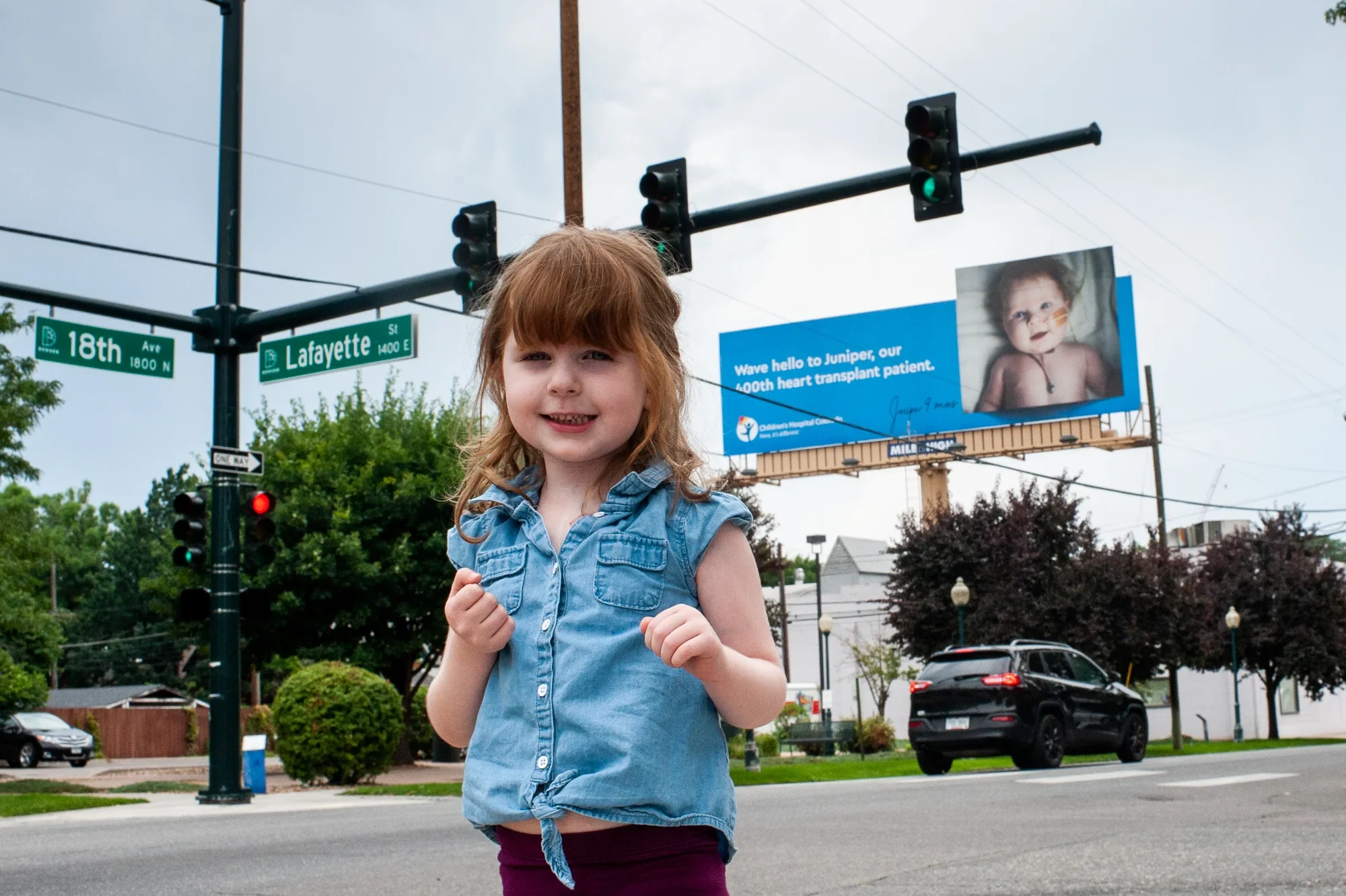 Juniper standing in front of her billboard