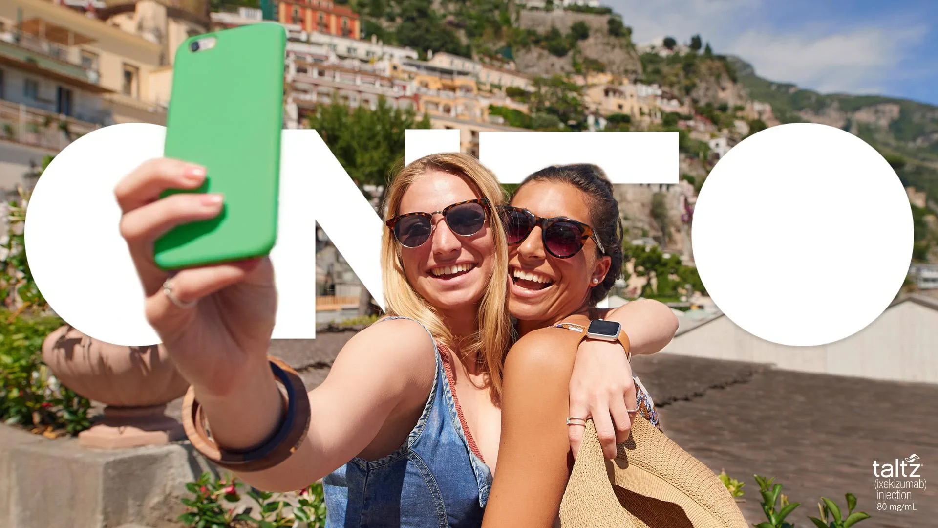 Two friends taking a selfie, framed by the word ONTO
