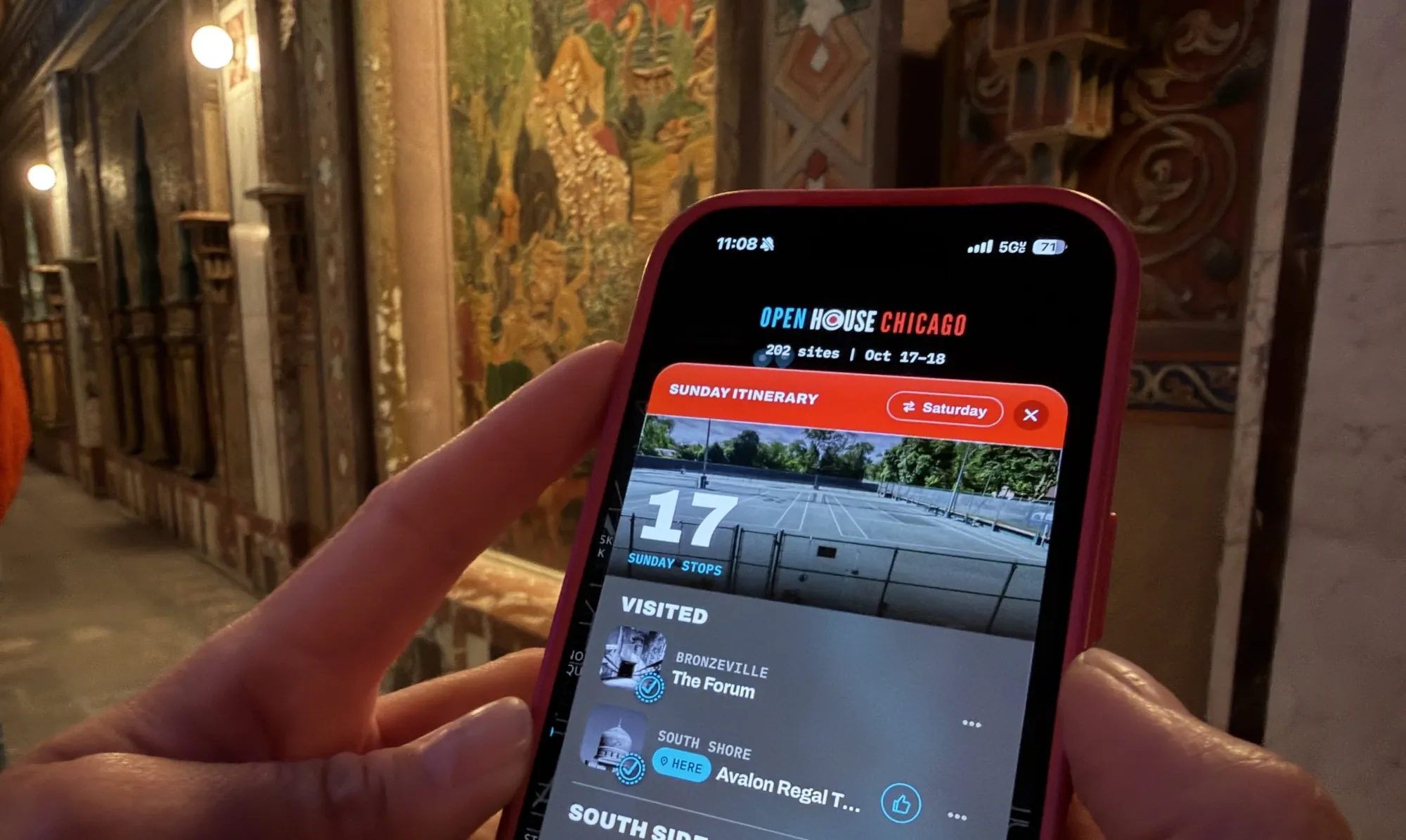 The app open on a phone in an ornate lobby
