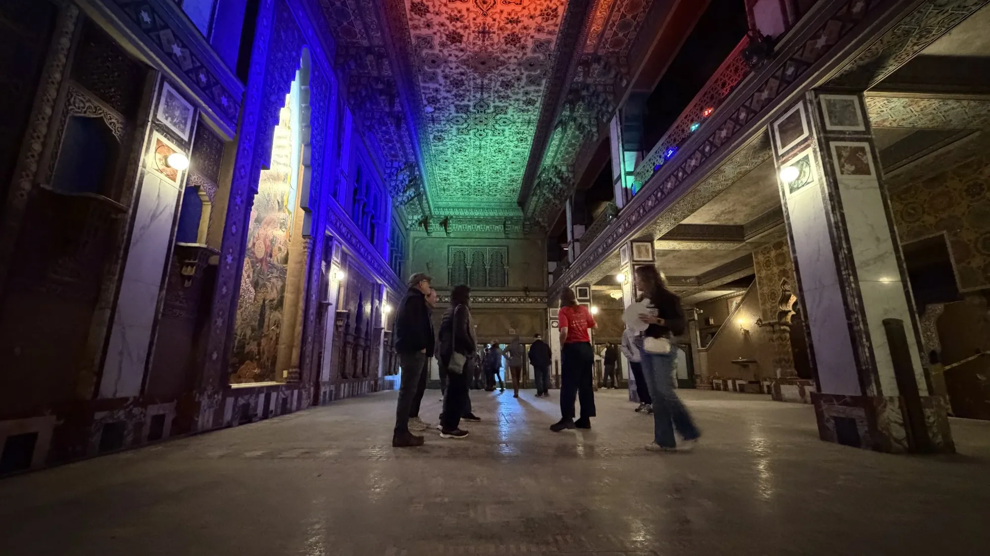 Visitors in a lit historic hall