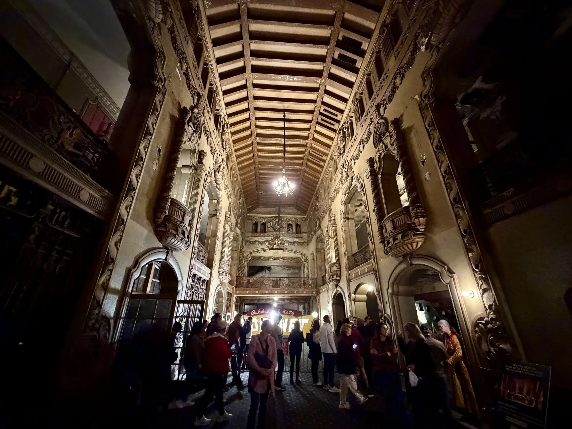 Visitors in a grand historic corridor